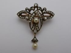 An Edwardian 9 ct yellow gold and silver brooch, bow shaped, the brooch set with approx. sixty pts