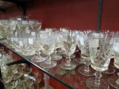 Collection of miscellaneous cut glass including water jug, seven red wine glasses, six white wine,