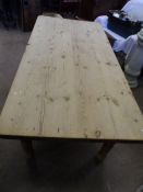 A pine farmhouse table approx. 180 x 88 x 75 cms. on turned legs, the table top being 4 cms thick