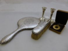 A pair of Birmingham hallmarked travelling candlesticks together with a Chester clothes brush and