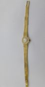 A lady`s 18ct gold 750 hallmarked Omega wrist watch, the watch having a round face with baton