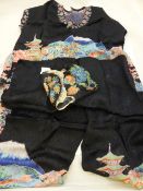 A pair of Japanese pyjamas in the original case together with two hand worked embroideries depicting