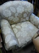 A modern swivel armchair upholstered in gold brocade.