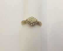 A lady`s 9 ct gold diamond cluster ring, approx. 15 pts. 2 gms total weight, size M