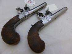 A pair of flintlock pocket pistols, circa 1810 with secret triggers and sliding safeties, the