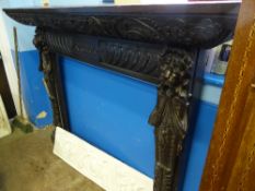 An antique carved oak fire surround having lion masks and laurels and the Latin inscription " Credo"