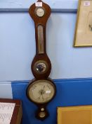 A mahogany cased barometer having mirror, thermometer and a dry / damp gauge, approx. 95 cms. long