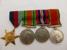 A group of four medals to 73481 T E McEwan incl. Defence, War, 1939 - 45 Star and Africa service