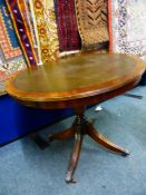 Reproduction circular leather topped occasional table on a centre column and four splayed legs