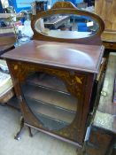 A Victorian mahogany display cabinet having inlaid decoration with an oval mirror to the top, the
