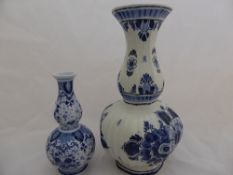 A double gourd Delft vase being flare lipped in traditional hand painted blue and white floral