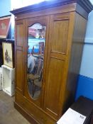 An Edwardian inlaid wardrobe having a drawer below with mirror door, approx. 170 x 200 x 44 cms.