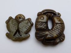 Two antique jade stone carvings in the form of two fish pendants