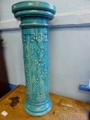 Turquoise Ceramic Plant Stand with raised floral design.