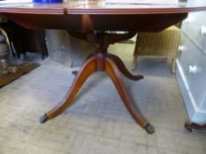 An oval Reproduction Beresford & Hicks Extending Dining Table on reeded legs together with six red