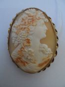 A fine Victorian shell cameo depicting a lady adorned with grapes and vines in a 9ct gold mount with