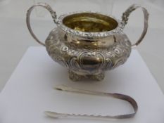 A William IV solid silver twin handled sugar bowl embellished with roses and leaves to handles, body