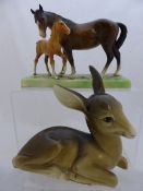 A Beswick study of a mare and foal, approx. 26 x 12 x 19 cms. together a Midwinter figure of a young
