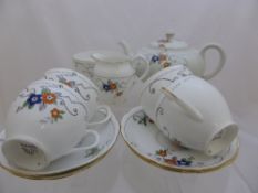 A Roslyn fine bone china tea service comprising eight cups, ten saucers, milk jug, sugar bowl,