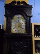 An impressive carved oak long case clock, the movement by Joseph Oxley, Norwich, the silver finished