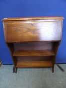 A small Edwardian oak bureau having open shelves to base, approx. 66 x 23 x 97 cms.