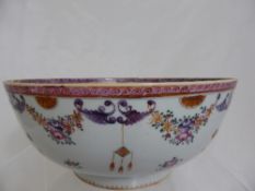 Circa 19th century famille rose bowl depicting flowers and lanterns on footed base with wave
