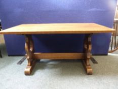 An oak coffee table on lyre style supports united by a pegged stretcher, approx. 37 x 46 x 46 cms.