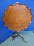 George III mahogany tilt top table, the table top with pie crust moulded edge on a vase form shaft