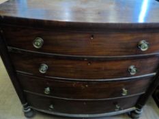 A Victorian bow fronted mahogany chest of drawers having four graduated drawers with reeded