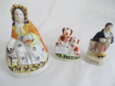 Three Staffordshire porcelain figures depicting Red Riding Hood, two miniature spaniels and a figure