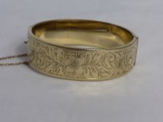 9 ct Gold Plated Bracelet with a metal core, the bracelet with floral scroll detail.