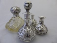 Three Silver Overlay Glass Perfume Bottles, together with a cut glass silver topped perfume bottle.