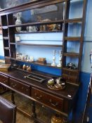 An 18th century oak welsh dresser, the open top having four shelves with two drawers to each side,