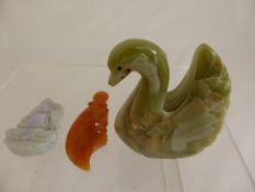 Green Agate Carving of a Swan together with a Jade Buddha and an orange stone Arabic knife.