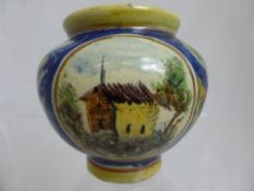 An antique hand painted Majolica vase depicting flowers and laurels on a cobalt background and