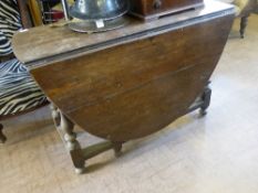 Antique Oval drop leaf table, the dark oak table on turned legs and stretchers (stretchers not