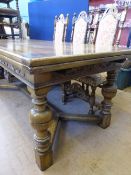 A large Oak Extending Dining Table with scroll detail and baluster turned legs, Y shaped