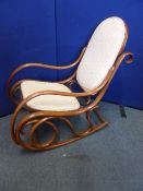 A Viennese Thonet style Bentwood rocking chair with upholstered seat and back.