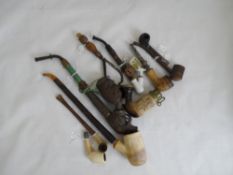 Miscellaneous collection of smoking pipes including a carved pipe depicting a stag`s head, a