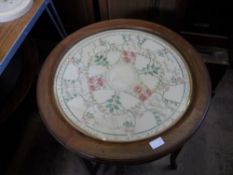 Edwardian mahogany occasional table, the circular top having a floral patterned embroidery under