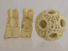 Oriental Carved Ivory Netsuke depicting two characters with birds, together with a Ivory Puzzle
