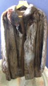 A black mink three quarter length fur coat, approx. length 81 cms, sleeves approx. 63 cms. in length