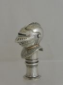 A solid silver lighter depicting a knight`s helmet and visor, the visor being hinged with a rose