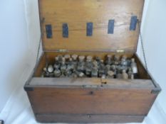 A vintage apothecary chest containing a quantity of original bottles and stoppers, to the front of