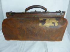 A vintage leather Gladstone bag