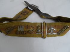 Stable belt with thirteen George VI crown era badges fixed, a mixture of cavalry, infantry and