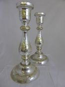 Pair of mercury candlesticks having floral decoration around the centre of each column, approx. 28