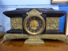 An Art Nouveau Black Slate and Brass Mantle Clock, the clock features circular dial with gilded