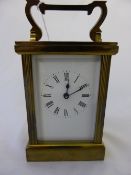 Continental brass carriage clock having a white enamel face.
