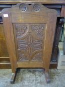 Arts and Crafts oak fire screen having carved decoration to the front